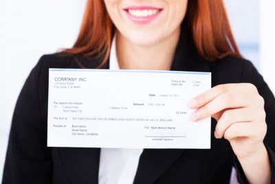 Woman holding paycheck