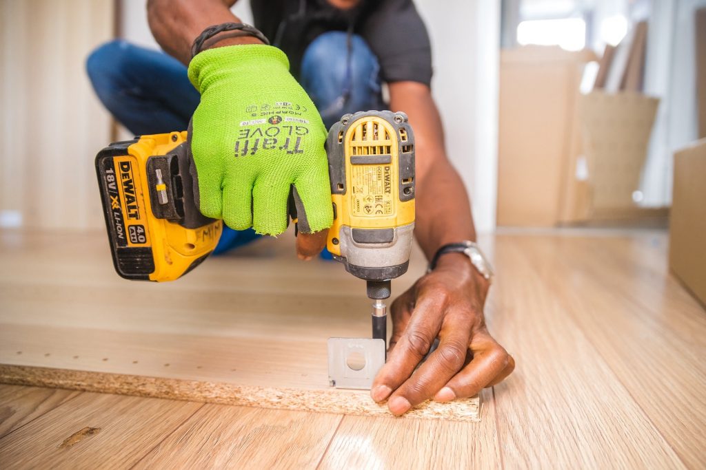 Handyman with drill making repair