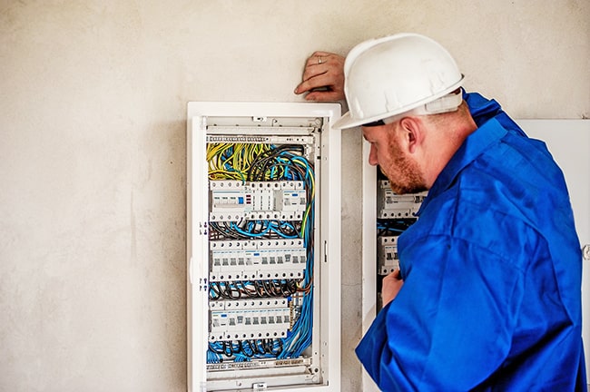 Home inspector looking at panel